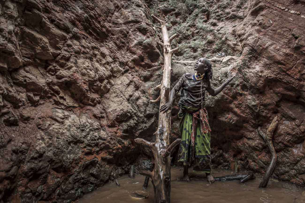 South Ethiopia. 2013. Borana ethnicity.A Borana woman inside a singingwell is getting water to take toground level. She needs the water forther animals. In this ectremely dryarea, water is taken from 20 metersdeep wells, where the aquifer is located.