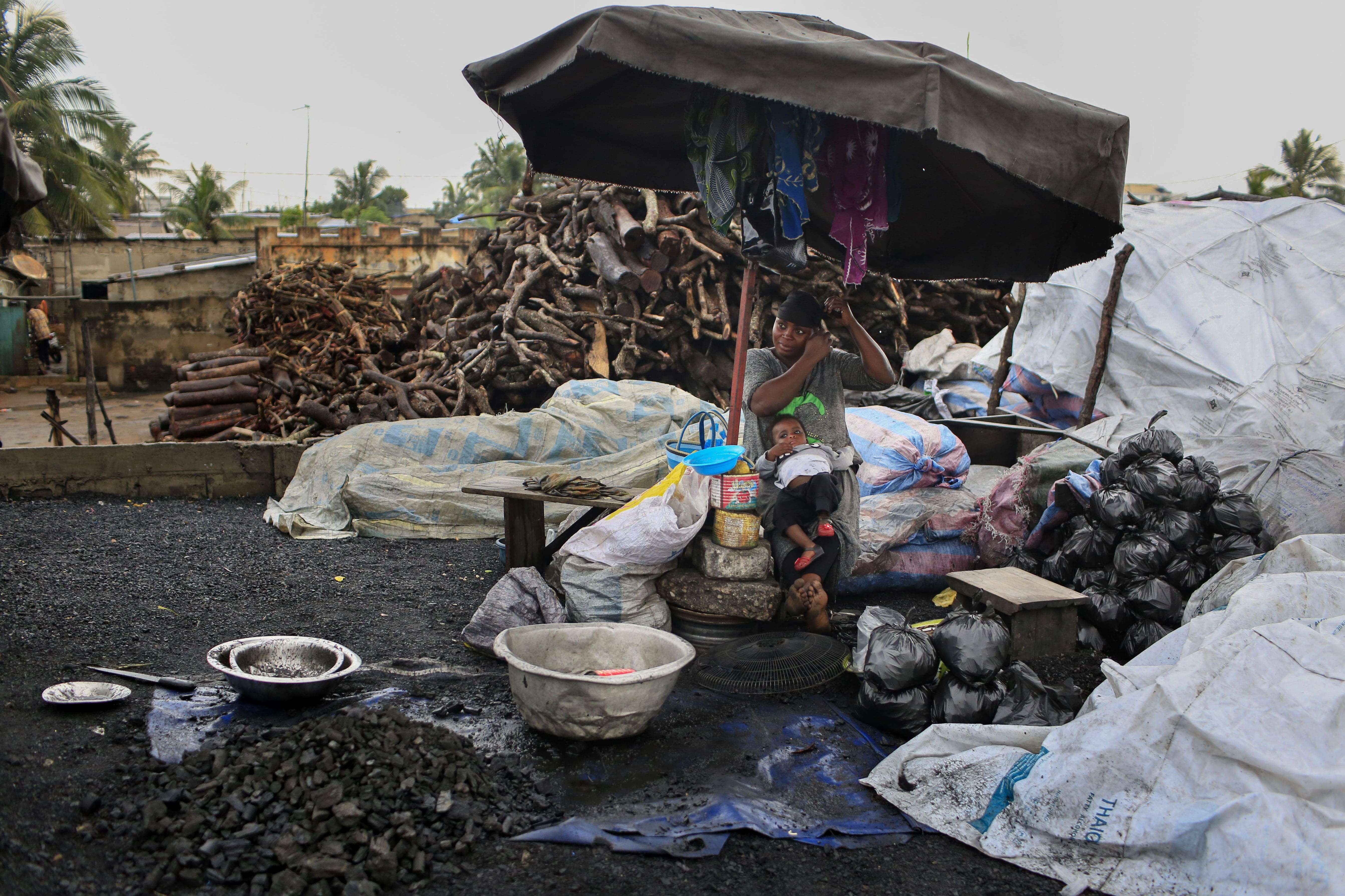 A charcoal seller at Ahnoukopé Market in Lomé. Across the country, people continue to use charcoal for heating and cooking.