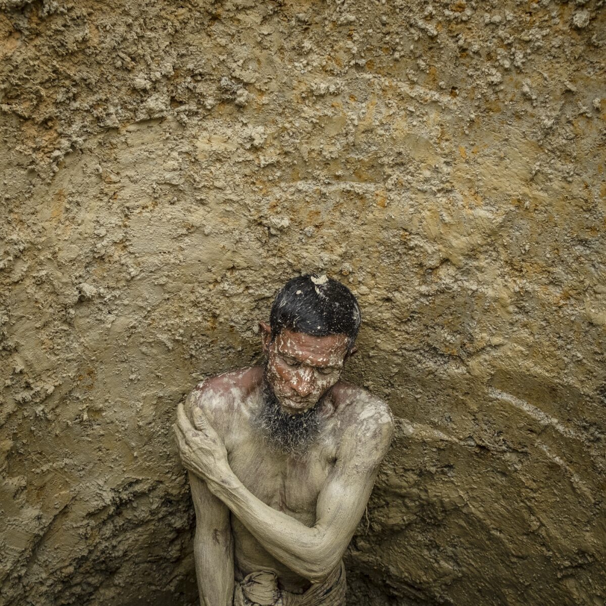 Balukhali-Kutupalong refugee camp, Ukhia subdistrict, Cox's Bazar, Bangladesh 16/08/2018 - Sixty-year-old Abdul Salam inside a hole he excavated to build a latrine. The inability to manage the massive quantity of waste generated by the camps is a major source of disease. The World Health Organisation reported in December 2017 that 88 percent of the water samples it had collected from households in the camps were contaminated by the bacteria E. coli from unmanaged faecal matter.